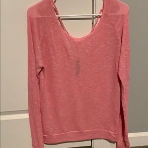 Aero pink sweater with open back.